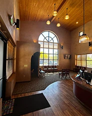 Spacious dental office lobby with wood ceiling and large arched window
